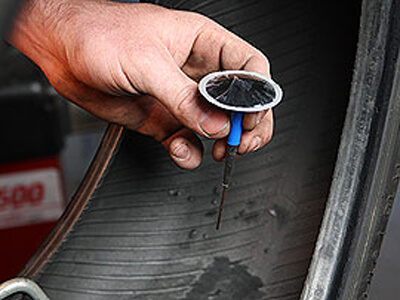 Tire technician repairing a tire in Phoenix